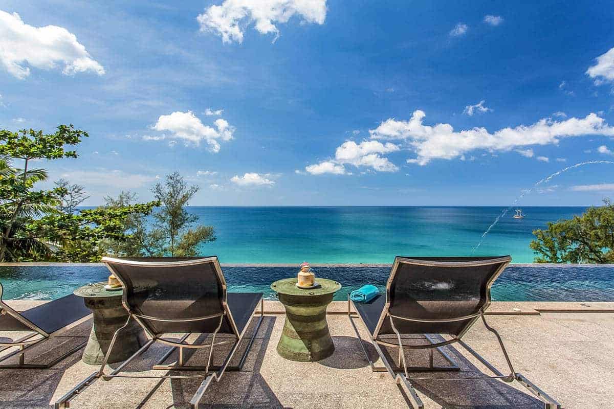 Infinity pool terrace with sun loungers overlooking the sea at a Phuket villa